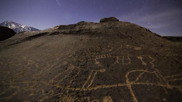 3 axis motion controlled astrophotography time lapse with dolly pull & pan left motion of moonset over Native American petroglyphs in Eastern Sierra, California