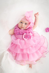 Portrait of a beautiful little baby girl in pink