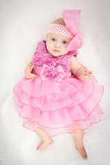 Portrait of a beautiful little baby girl in pink