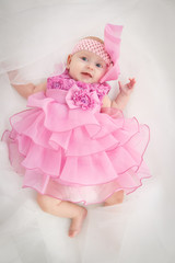 Portrait of a beautiful little baby girl in pink