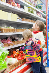 two girls  at   grocery store.