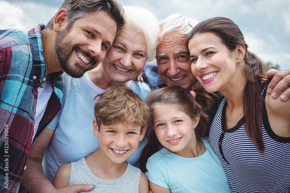 Wall mural Happy multi-generation family standing  outdoors