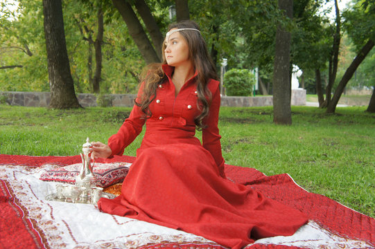 young eastern appearance woman in the summer park