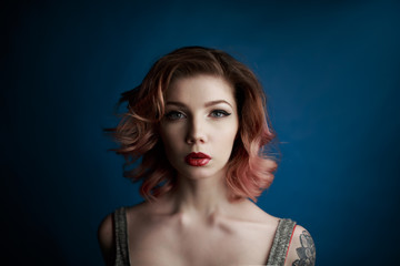 Portrait of a beautiful young girl with tattoo in the Studio