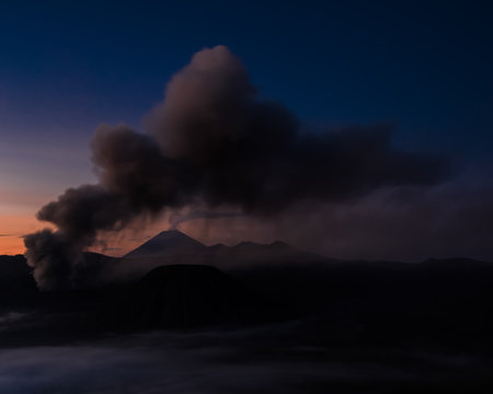 Smoke and ash from the volcano hovering over the water (Bohorok, Indonesia)