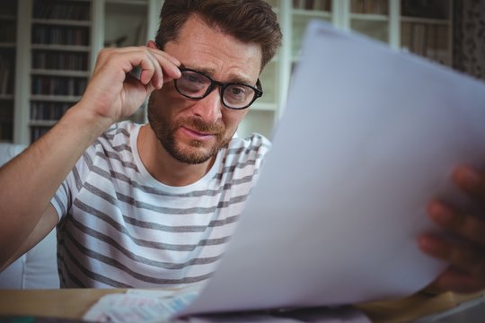 Worried Man Looking At His Bills