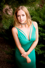 Portrait of a beautiful woman in a green dress