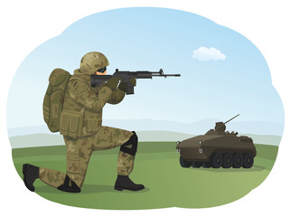 Soldier in uniform is standing on one knee and ready to fight. Shooting training. Armored troop carrier on the background.