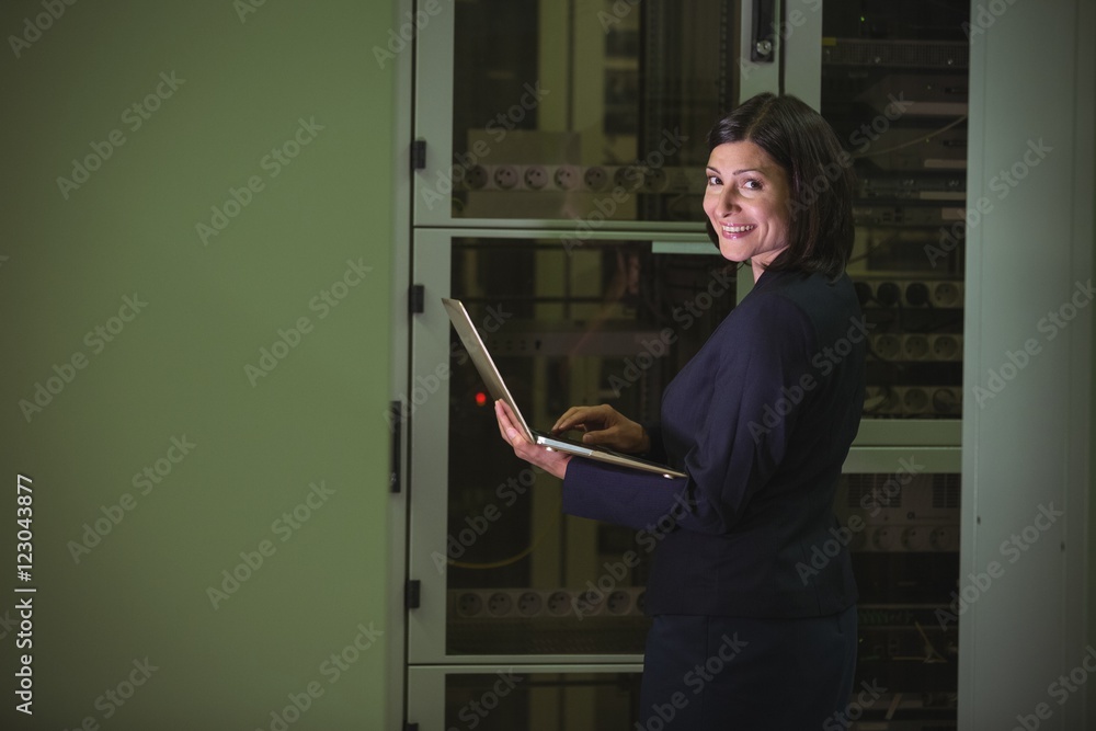 Aufkleber Technician using laptop while analyzing server