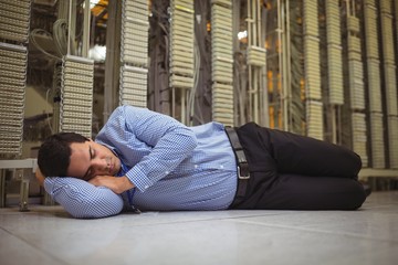 Tried technician sleeping on tiled floor