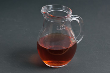 glass jug with infusion of oak bark at the blackboard