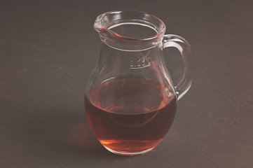 glass jug with infusion of oak bark at the blackboard