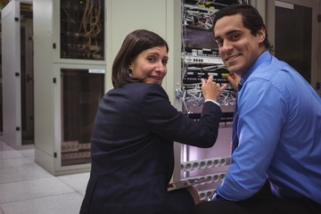 Portrait of technicians analyzing server