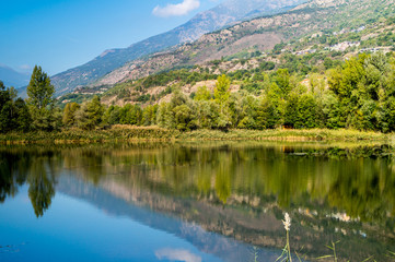 mountains, sky and clouds reflected in the lake