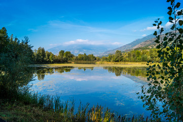mountains, sky and clouds reflected in the lake