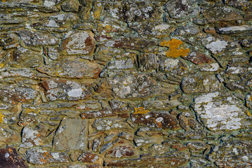 texture of a wall with rock stones slate and lichen in Salorino, Caceres, in Extremadura, Spain