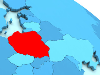 Poland in red on blue globe