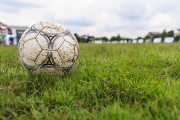 Nakhon Ratchasima, Thailand - October 1 : Muddy soccer ball on a football field in Municipal...
