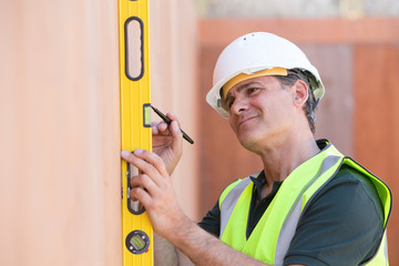 Builder Measuring With Spirit Level