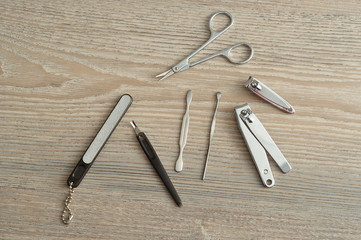 A manicure set or tools on a wooden background