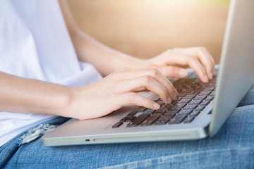 Naklejka premium Hands of a woman working with computer,outdoor.