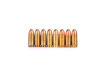9mm.bullets 8 shots abreast oneline on white background