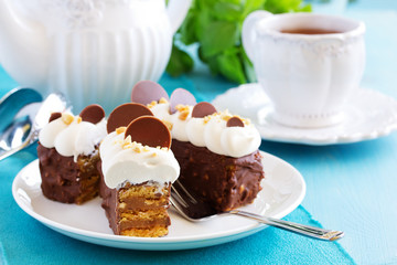 Chocolate cake with caramel, peanut cream "shibust." Selective focus.