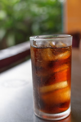 Close-up glass of cola with ice cubes,vintage picture style
