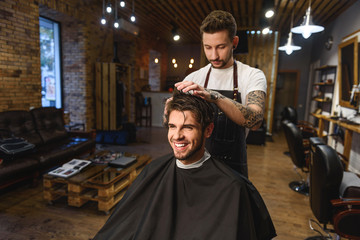 close up of happy man and hairstylist