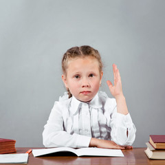 Schoolgirl raising her hand knowing the answer