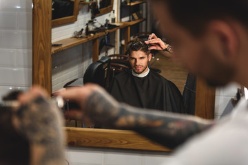 man sitting at barbershop
