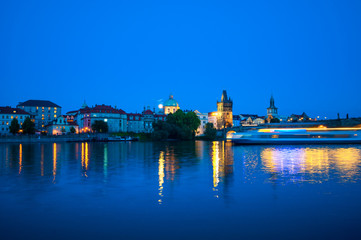 Fototapeta na wymiar Viewing on Vltava river and Prague cityscape at night