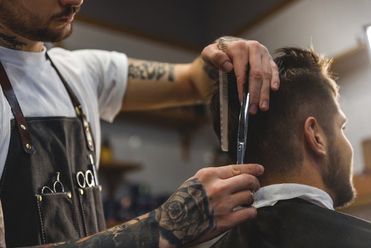 barber with scissors at work