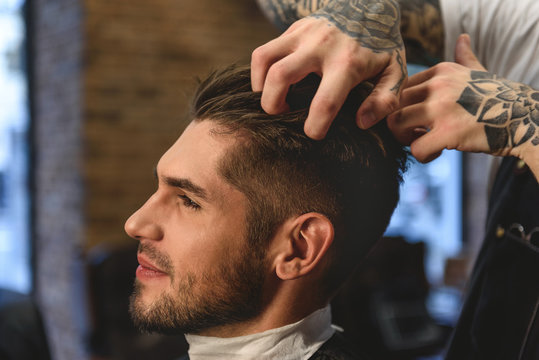 barber scratching head of a customer