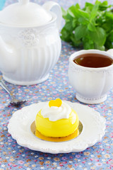 Cake with orange mousse and almond krokantom in the mirror glaze. Selective focus.