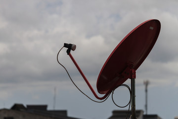 Red satellite dish on the roof in rainy day,thailand