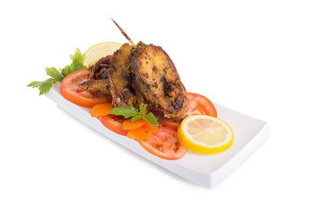 Fried fish in a plate with ingredients