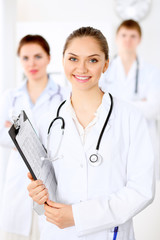 Fototapeta premium Happy doctor woman with medical staff at the hospital