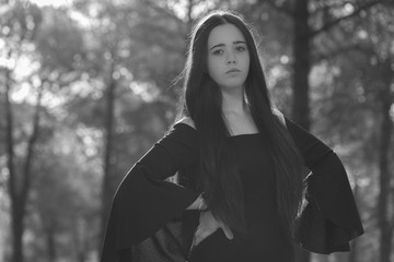 Portrait of young woman clutching the lapels of his jacket.