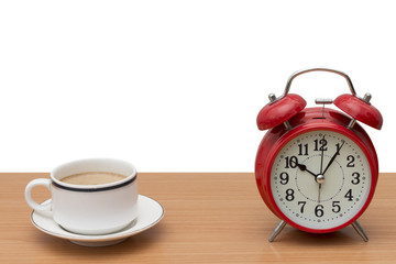 coffee and alarm clock on wood table