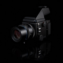 Proffessional medium format film camera with prism finder and portrait lens attached on isolated...