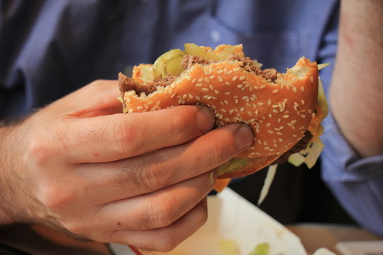 Man holding a hamburger