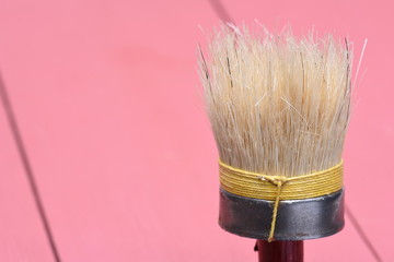 Paintbrush on wood background closeup