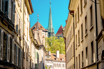 Street view with old buildings and Saint Pierre church's spire in the old town of Geneva city in...