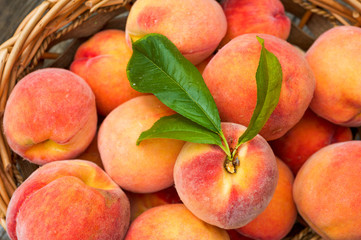 Naklejka na ściany i meble Close up of ripe peaches in a basket