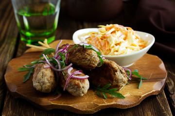 Kyufta kebab with salad close-up.