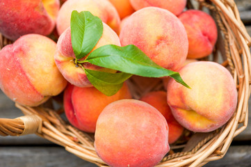 Close up of a basket of ripe peaches