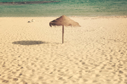 Umbrella beach. Empty beach with wooden umbrella