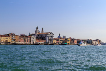 Fototapeta na wymiar The boat floats on the Giudecca Canal in the Italian city of Venice