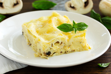 A piece of lasagna with chicken and mushrooms.